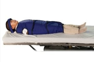a 6-year-old child wrapped tightly in a blanket, restraining his arms and legs