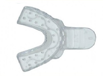 A photo of a lower impression tray, showing it extending only far enough in the back to register the teeth.